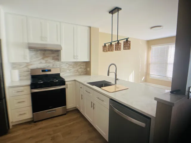 a kitchen with appliances cabinets and a sink