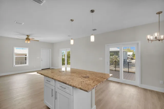 a kitchen with stainless steel appliances granite countertop a stove top oven a sink and a refrigerator