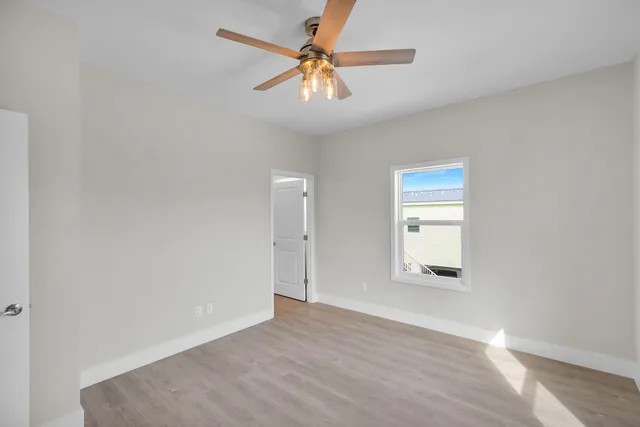 wooden floor in an empty room with a window
