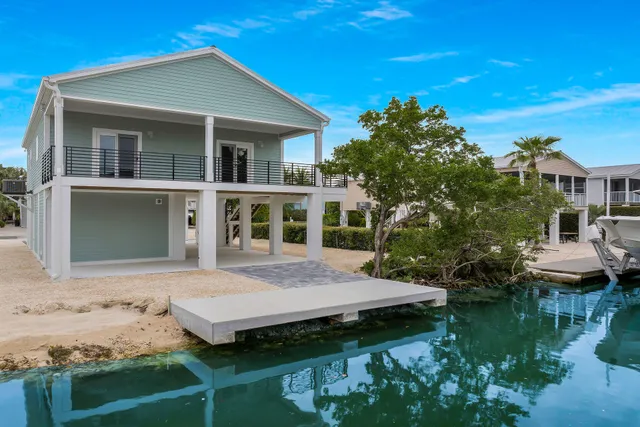 a view of a house with pool garden and patio