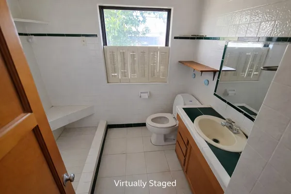 a bathroom with a sink a toilet and a window