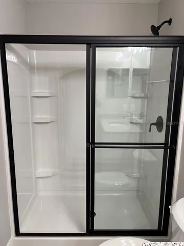 a bathroom with a toilet and a shower