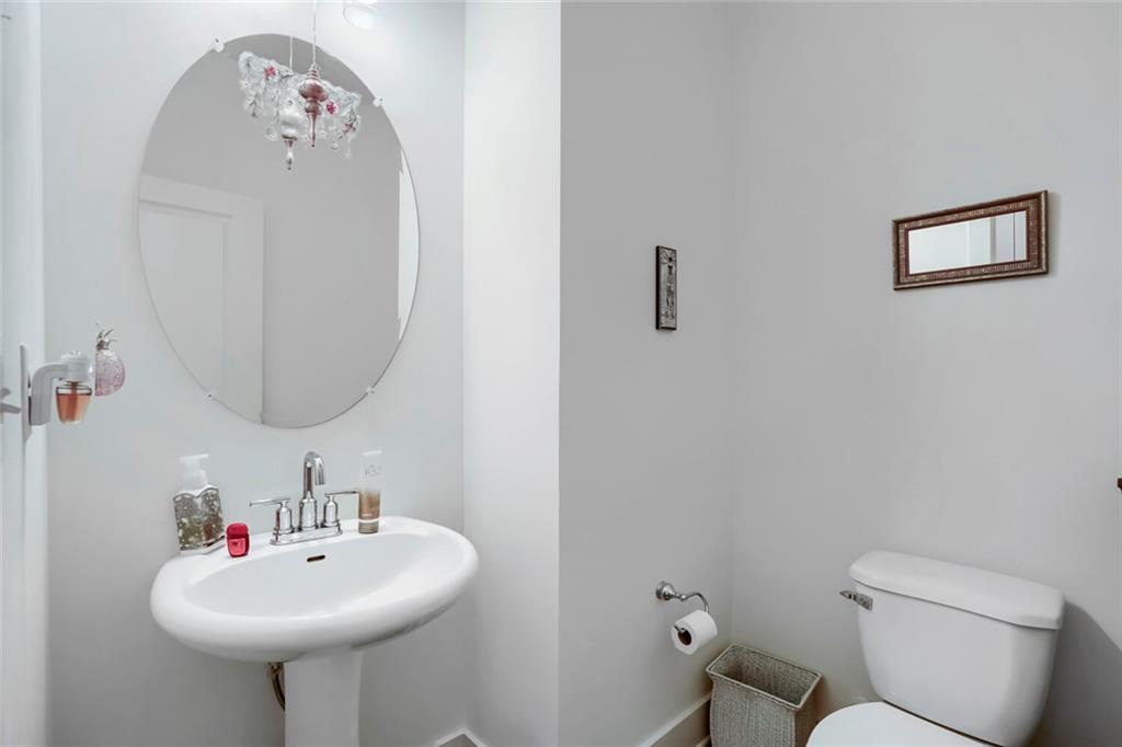 76 Garrison Drive Winder, GA 30680 - Photo 13 of 26 a bathroom with a sink mirror and toilet