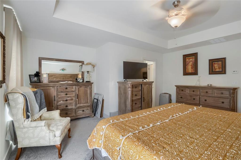 76 Garrison Drive Winder, GA 30680 - Photo 19 of 26 a bedroom with a bed and a flat screen tv