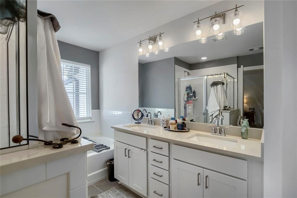 76 Garrison Drive Winder, GA 30680 - Photo 20 of 26 a bathroom with double vanity and a mirror