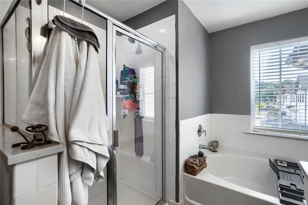 76 Garrison Drive Winder, GA 30680 - Photo 21 of 26 a bathroom with a tub and a window