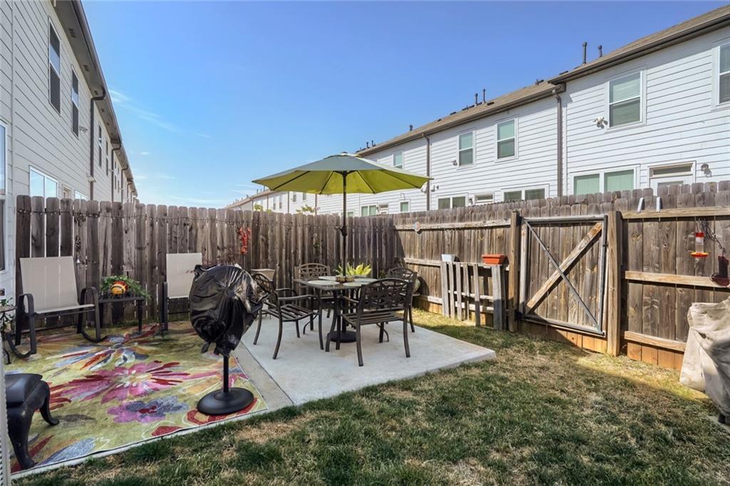 76 Garrison Drive Winder, GA 30680 - Photo 24 of 26 a view of a dinning tables and chairs in patio