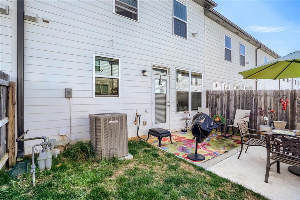 76 Garrison Drive Winder, GA 30680 - Photo 25 of 26 a view of a patio with a table and chairs under an umbrella