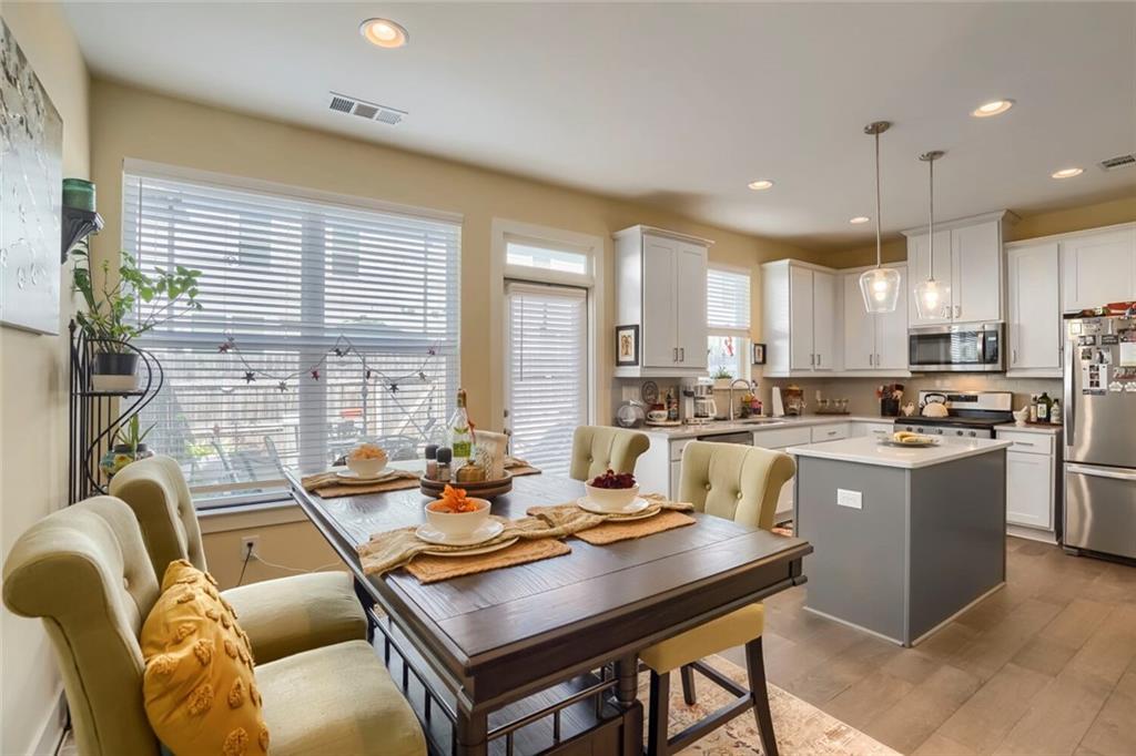 76 Garrison Drive Winder, GA 30680 - Photo 8 of 26 a kitchen with a table chairs stove and kitchen island