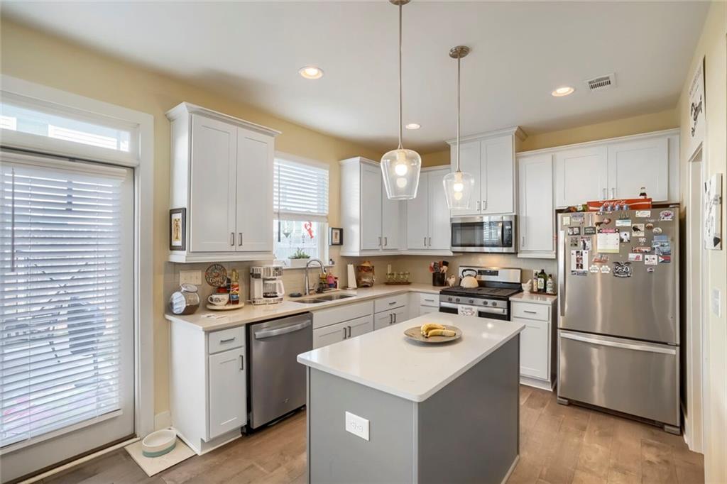 76 Garrison Drive Winder, GA 30680 - Photo 9 of 26 a kitchen that has a lot of cabinets a sink and a refrigerator in it