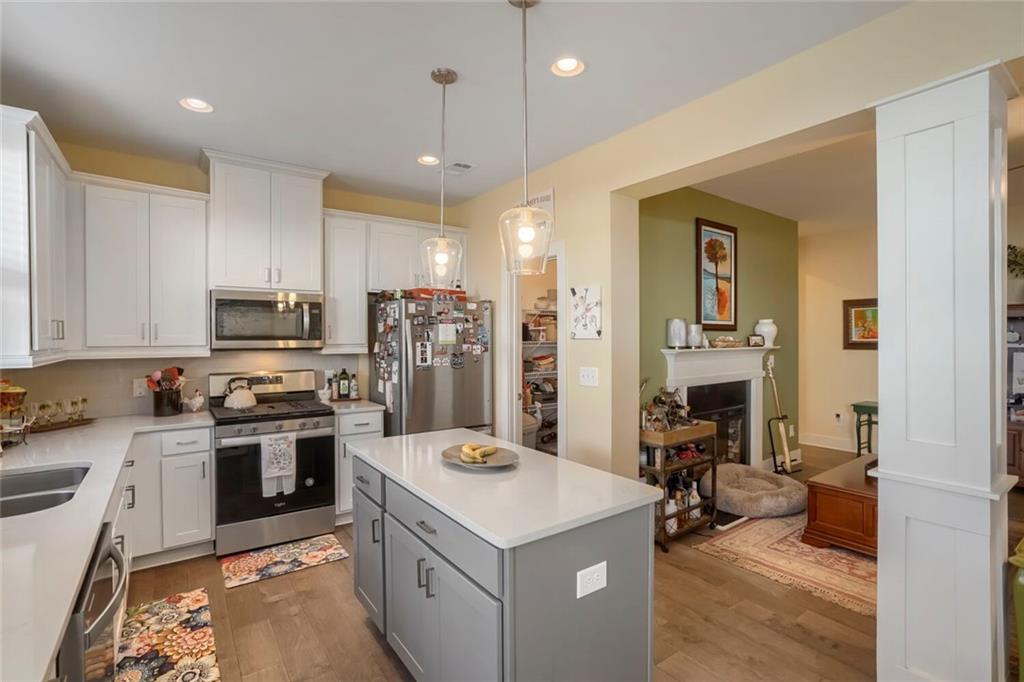 76 Garrison Drive Winder, GA 30680 - Photo 10 of 26 a kitchen with a sink stove and refrigerator