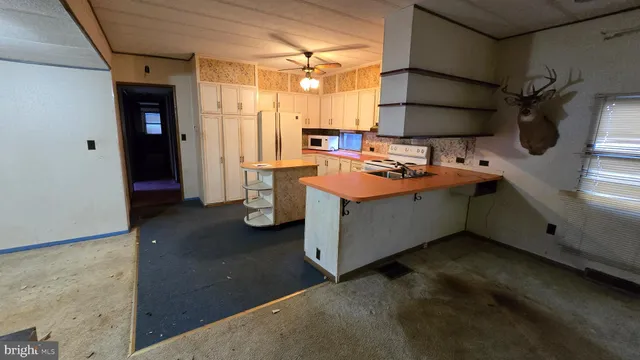 a kitchen with stainless steel appliances a sink stove and cabinets