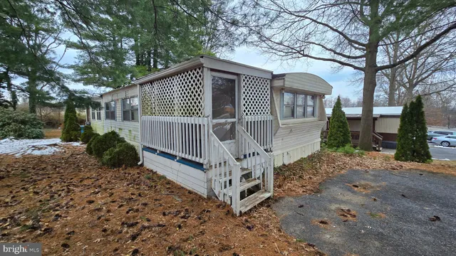 a view of house with a yard and pathway