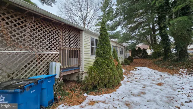 a view of a yard with plants and wooden fence