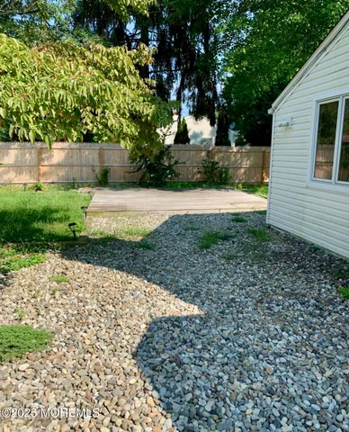 a view of a backyard with large trees