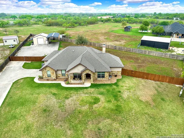 a aerial view of a house with swimming pool and a yard