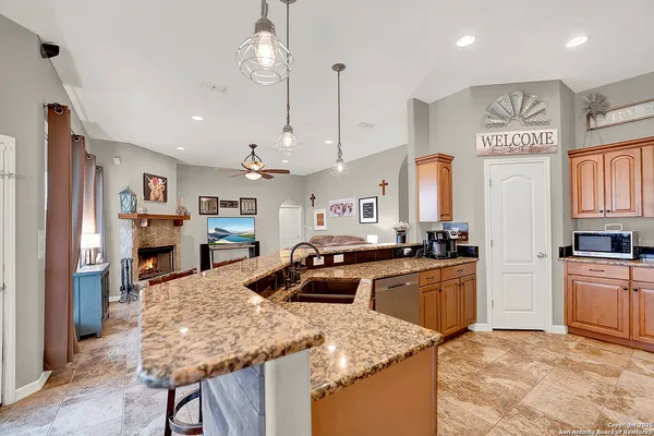 a kitchen with stainless steel appliances granite countertop a stove a sink and a microwave