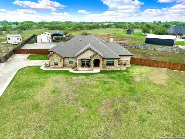 an aerial view of a house with swimming pool garden and patio