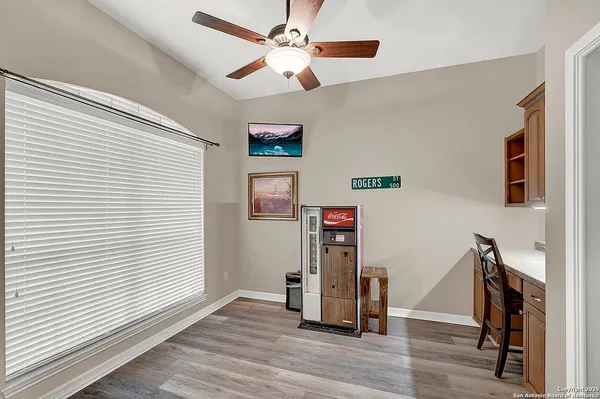 a view of a house with a big yard and large tree
