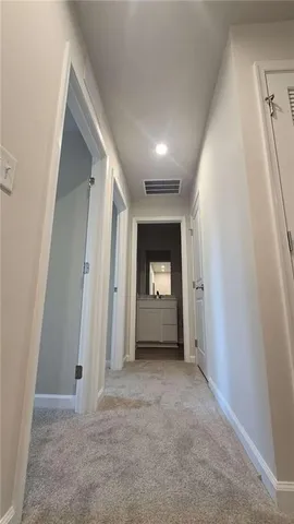 a spacious bathroom with a double vanity sink and a mirror