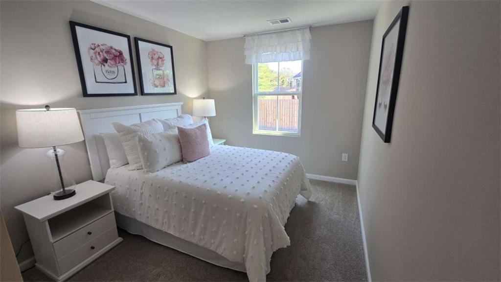 12 Downing Drive Adairsville, GA 30103 - Photo 2 of 36 a bedroom with a bed and a lamp on dresser