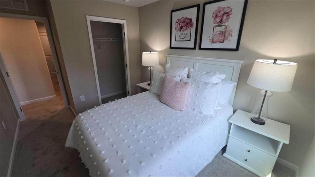 12 Downing Drive Adairsville, GA 30103 - Photo 26 of 36 a bedroom with a bed and a lamp on table