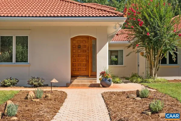 a vase of flowers sitting on a table in front of a window