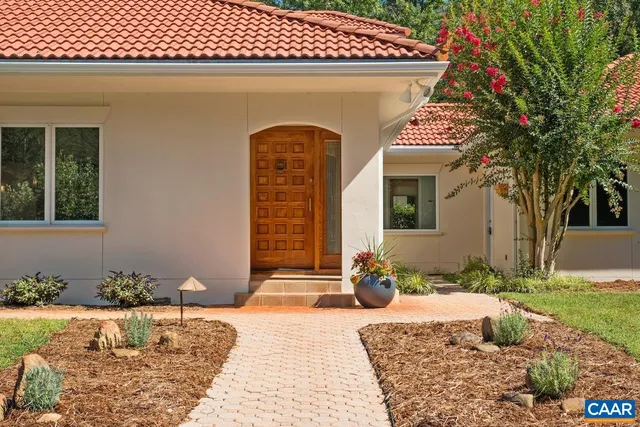a vase of flowers sitting on a table in front of a window