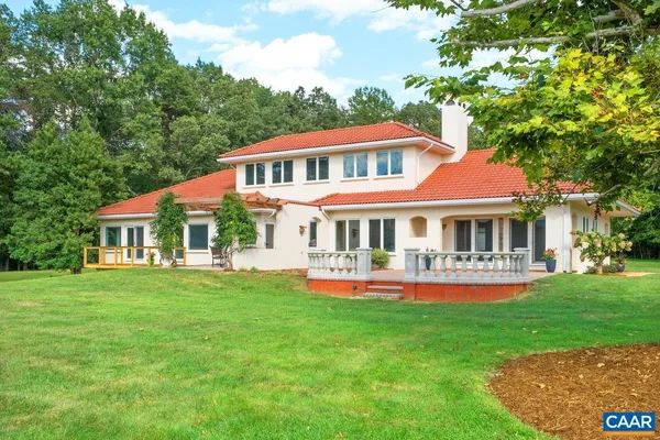 a front view of a house with a yard table and chairs