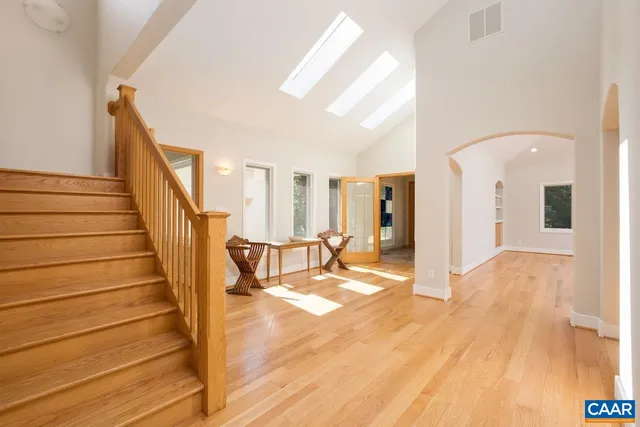 a view of hallway with a large window and wooden floor