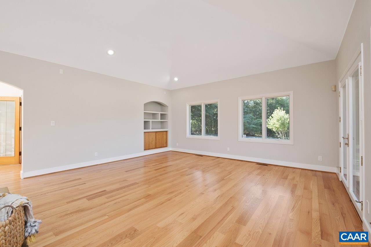 8540 Taylor Creek Road Afton, VA 22920 - Photo 24 of 71 a view of an empty room with wooden floor and a window