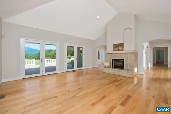 a living room with a stove and a window