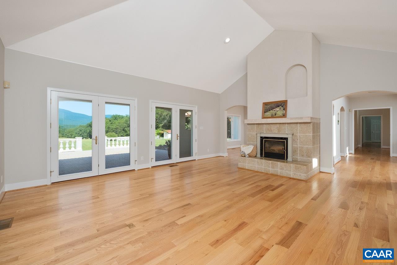 8540 Taylor Creek Road Afton, VA 22920 - Photo 25 of 71 a view of empty room with wooden floor and fireplace
