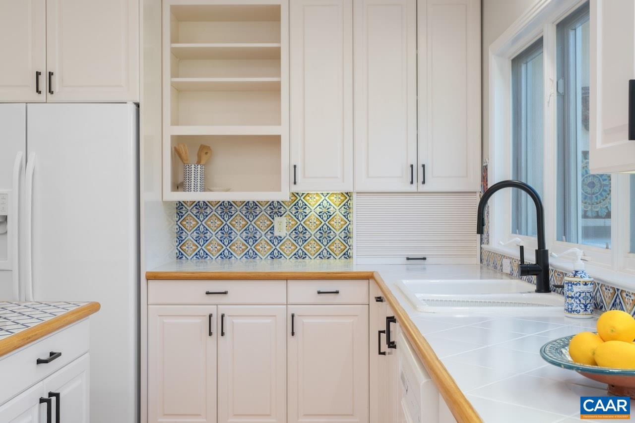 8540 Taylor Creek Road Afton, VA 22920 - Photo 32 of 71 a kitchen with stainless steel appliances granite countertop a sink and a white cabinets