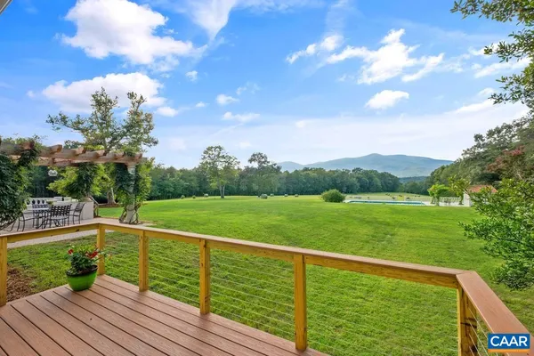 a view of an swimming pool and trees in the background