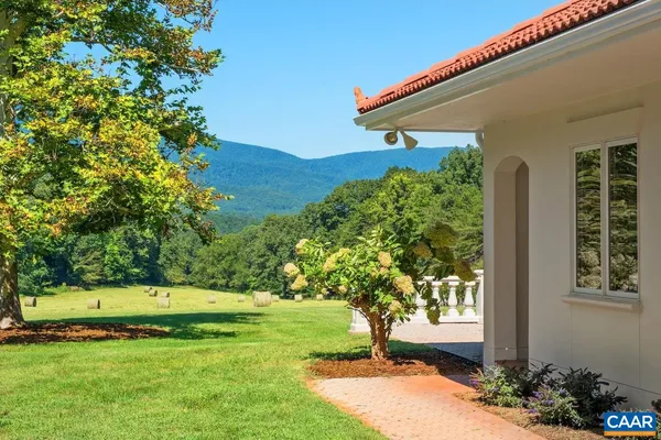 a view of a patio with a table chairs and a yard