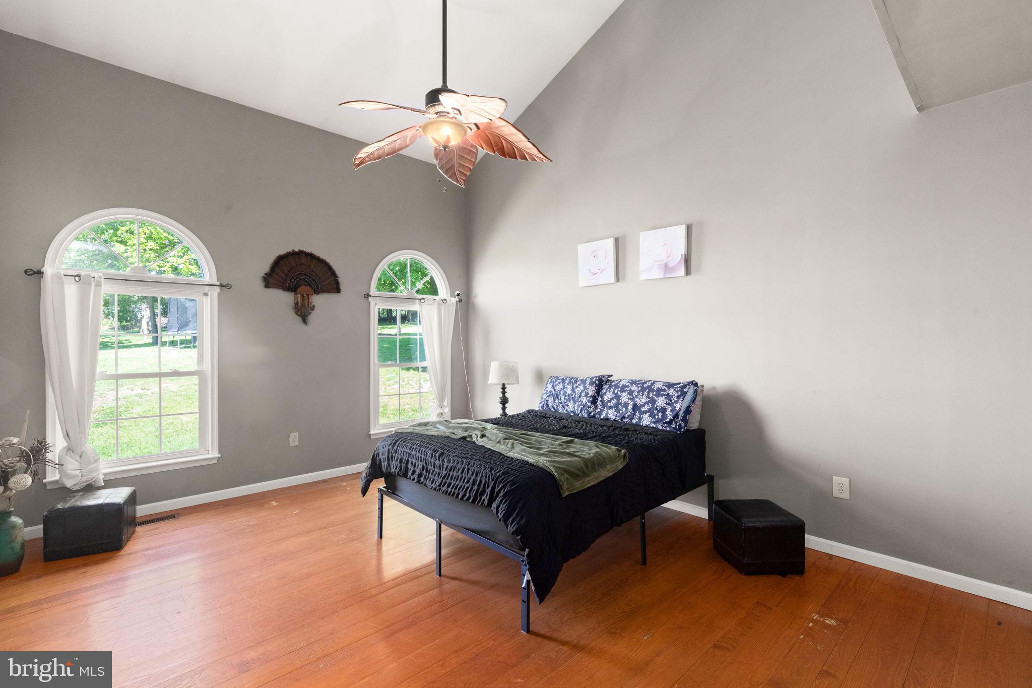 2140 Marston Road New Windsor, MD 21776 - Photo 18 of 48 a bedroom with a bed and a chandelier