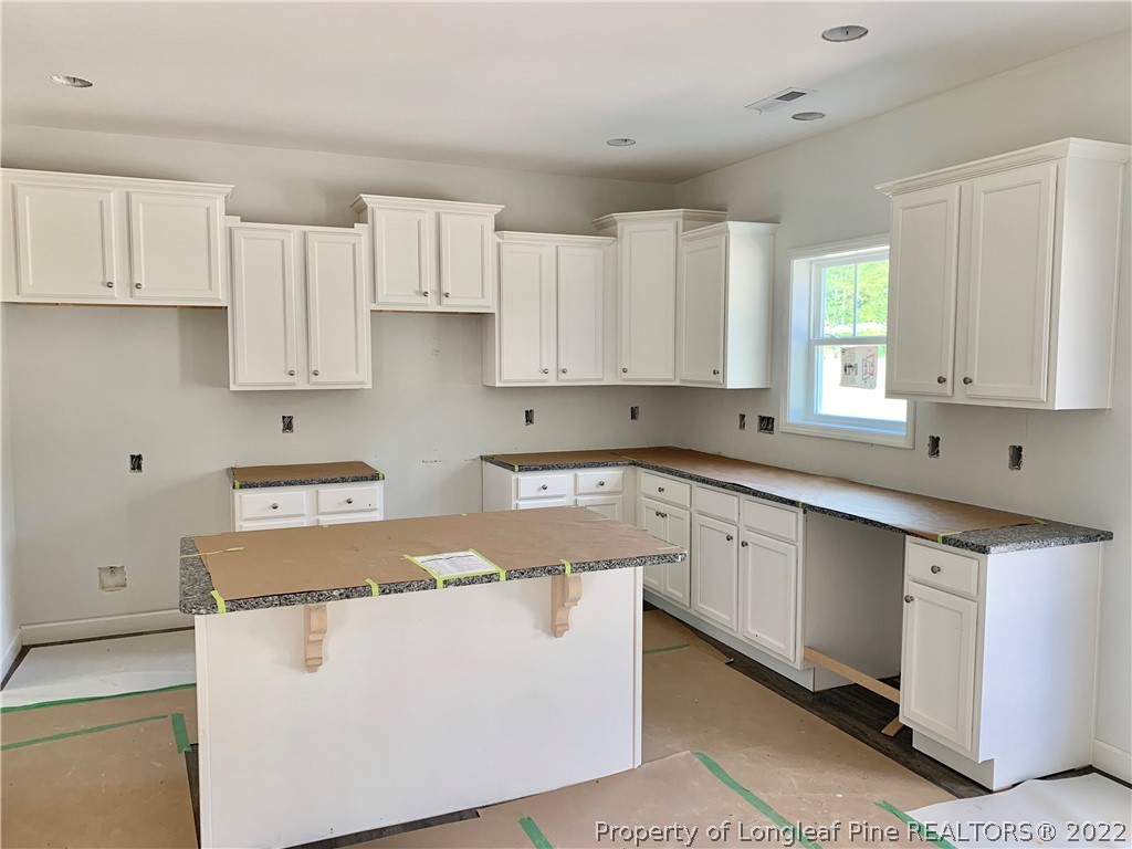 775 Montrose Road Raeford, NC 28376 - Photo 3 of 15 a kitchen with cabinets appliances a sink and a window