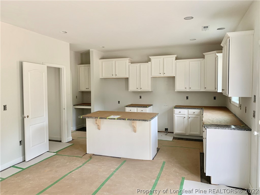 775 Montrose Road Raeford, NC 28376 - Photo 6 of 15 a kitchen with a sink a stove and a refrigerator
