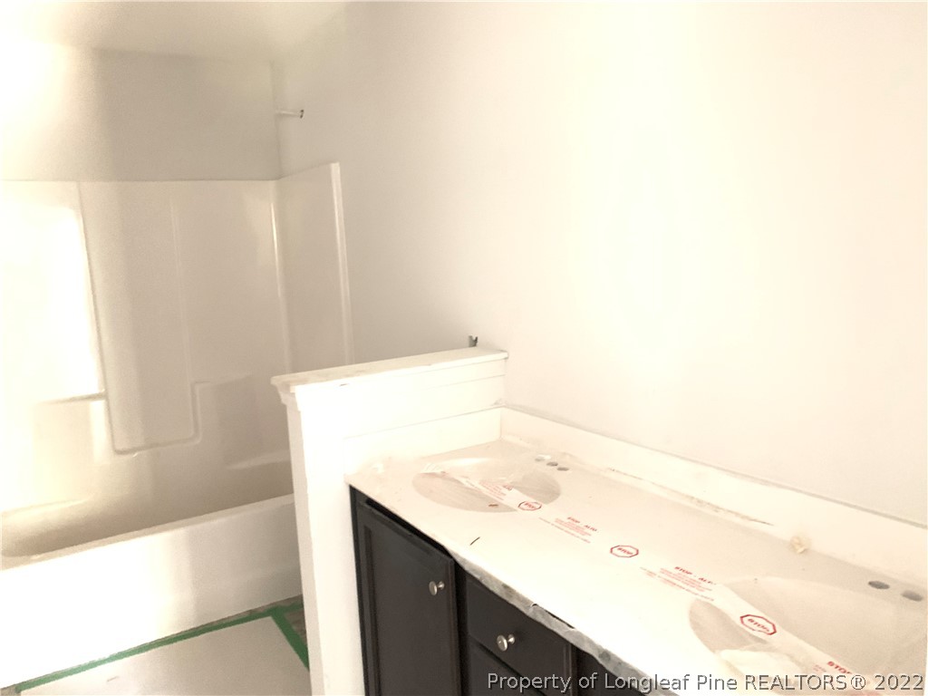 775 Montrose Road Raeford, NC 28376 - Photo 10 of 15 a bathroom with a sink and a bathtub