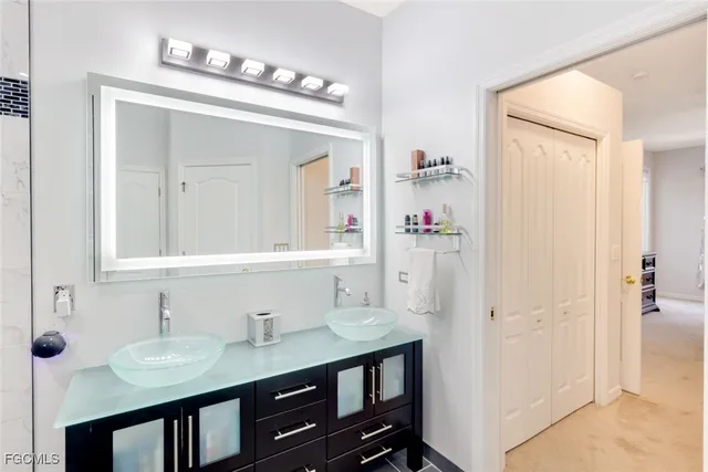 a bathroom with a sink vanity and a mirror
