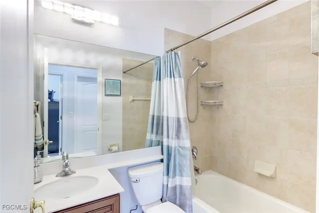 a bathroom with a sink mirror toilet and bathtub