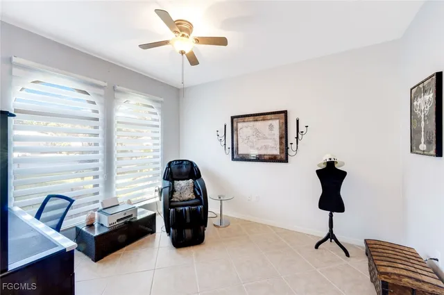 a view of a livingroom with workspace and a window