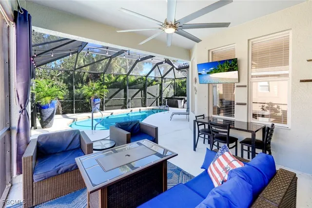 a living room with furniture a table and a large window
