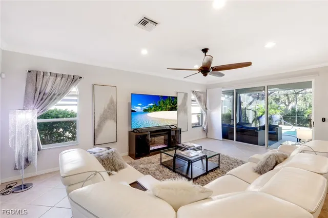 a living room with fireplace furniture and a large window