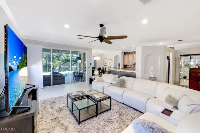 a living room with furniture a table and a flat screen tv