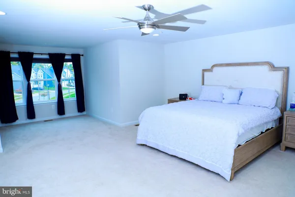 a bathroom with a sink vanity mirror and toilet
