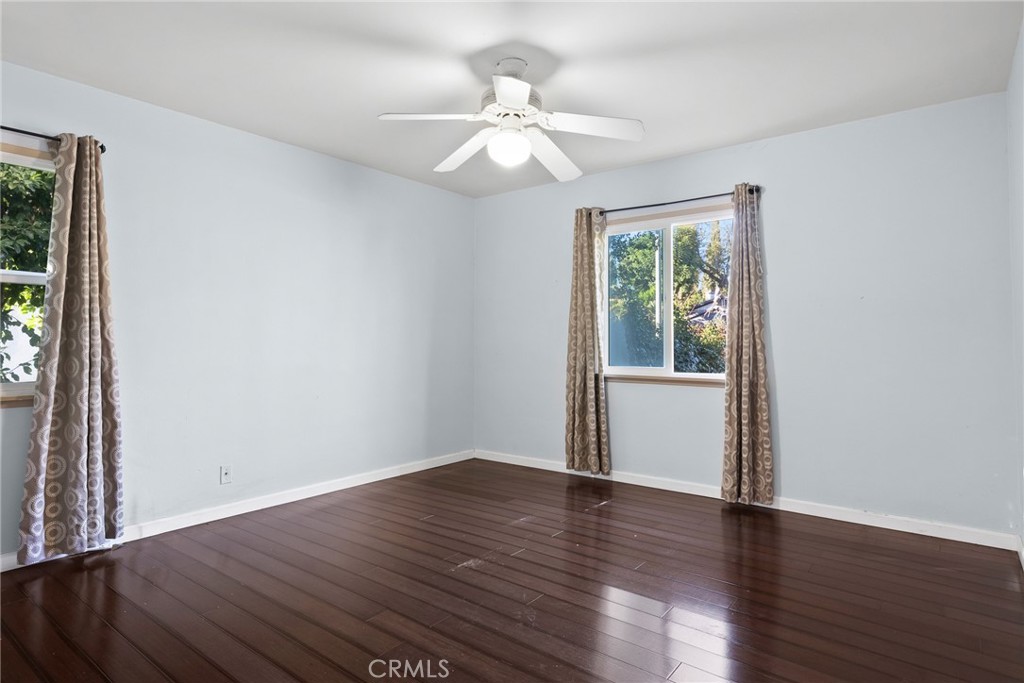 17806 Erwin Street Encino, CA 91316 - Photo 6 of 62 a view of an empty room with wooden floor and a window