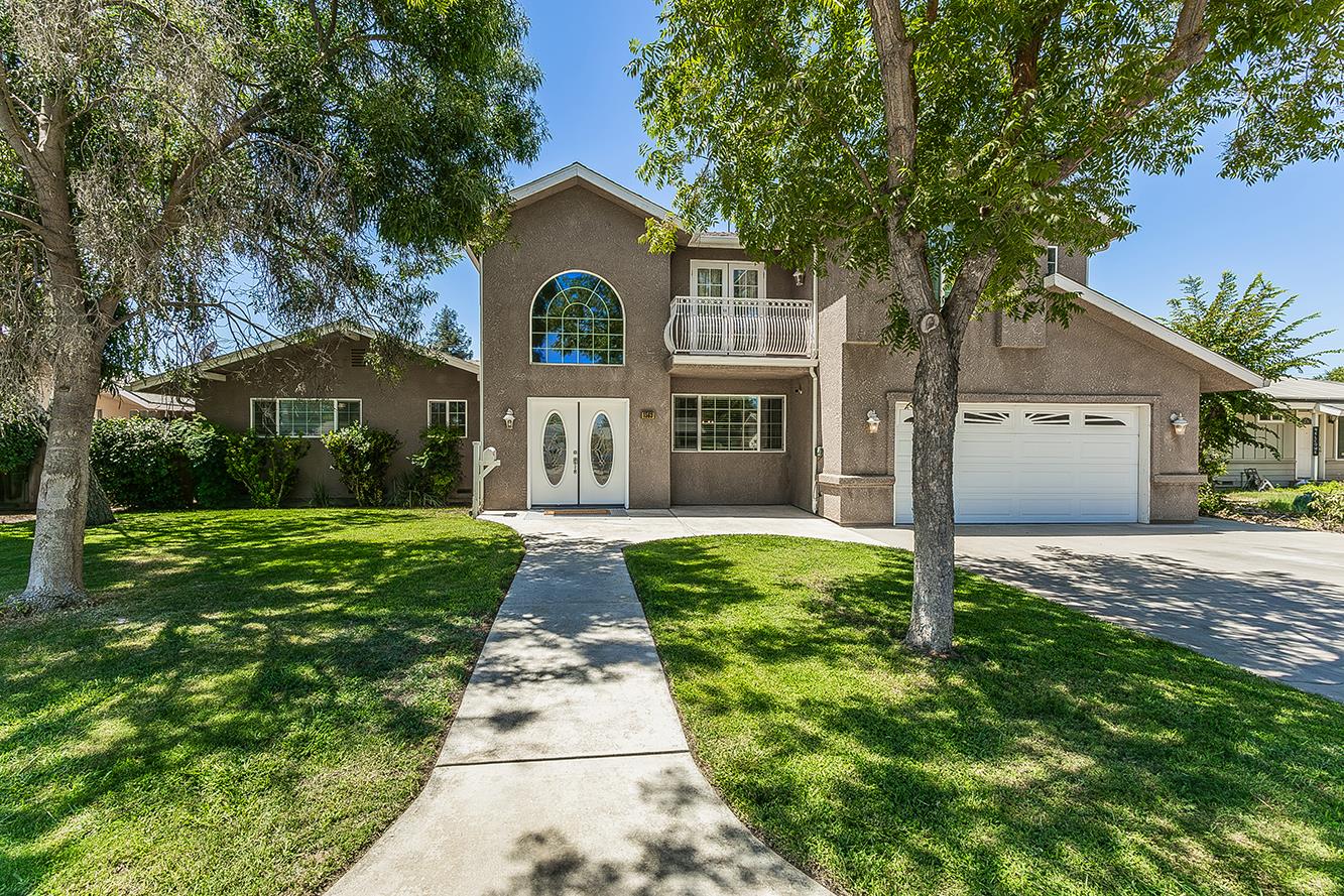 1563 South Klein Avenue Reedley, CA 93654 - Photo 1 of 81 a front view of a house with yard and green space