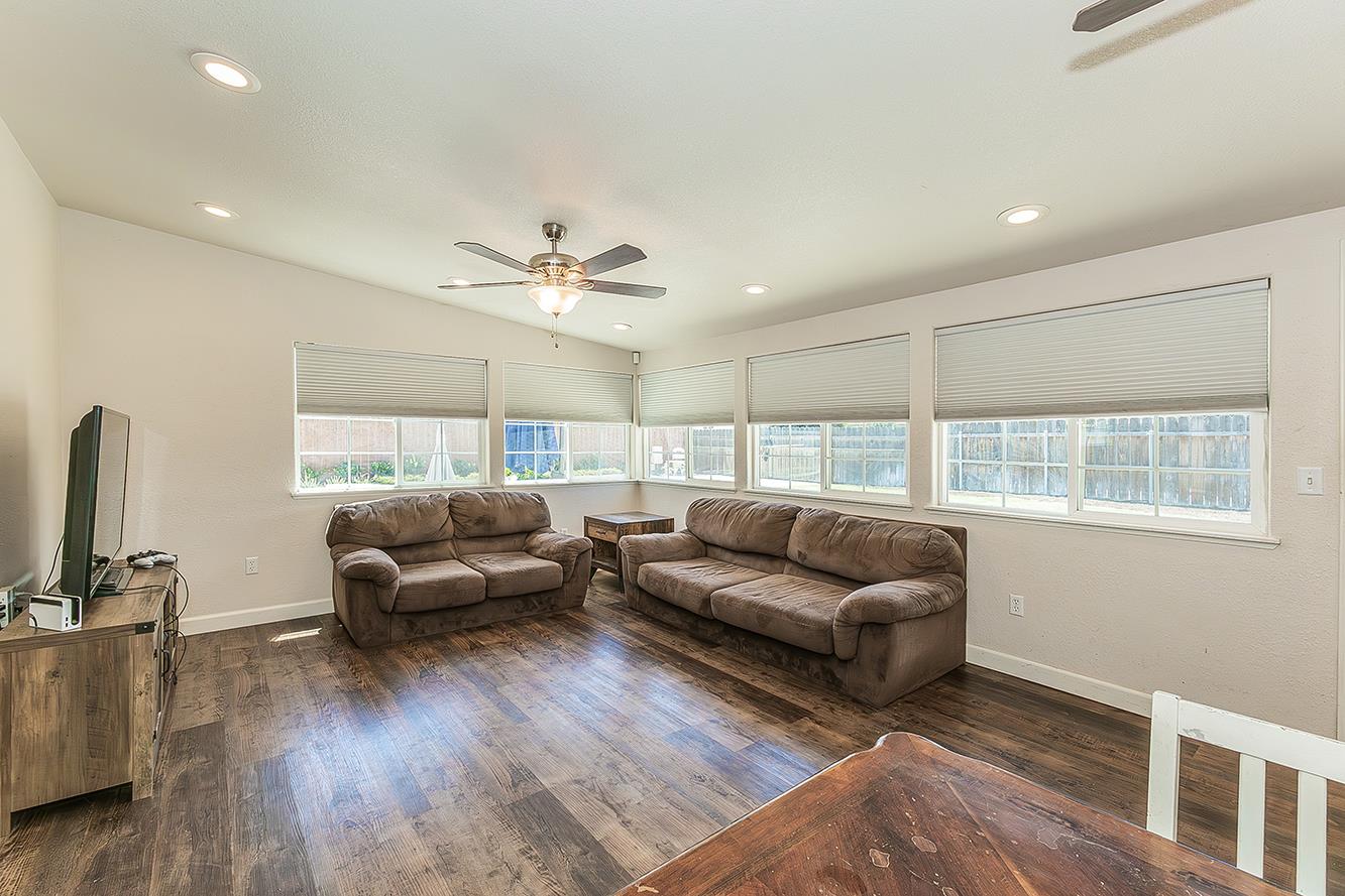 1563 South Klein Avenue Reedley, CA 93654 - Photo 15 of 81 a living room with furniture and wooden floor